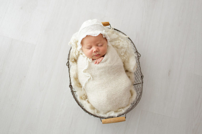 baby girl in white basket