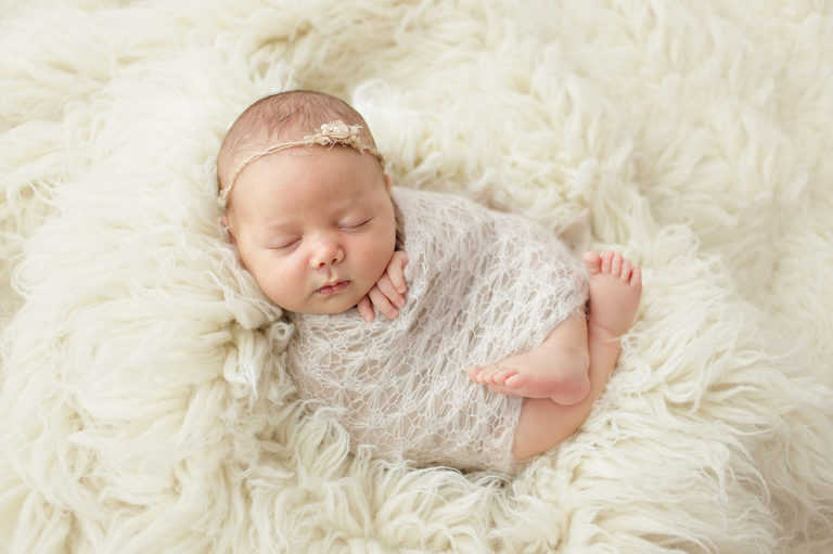 baby girl on white float rug