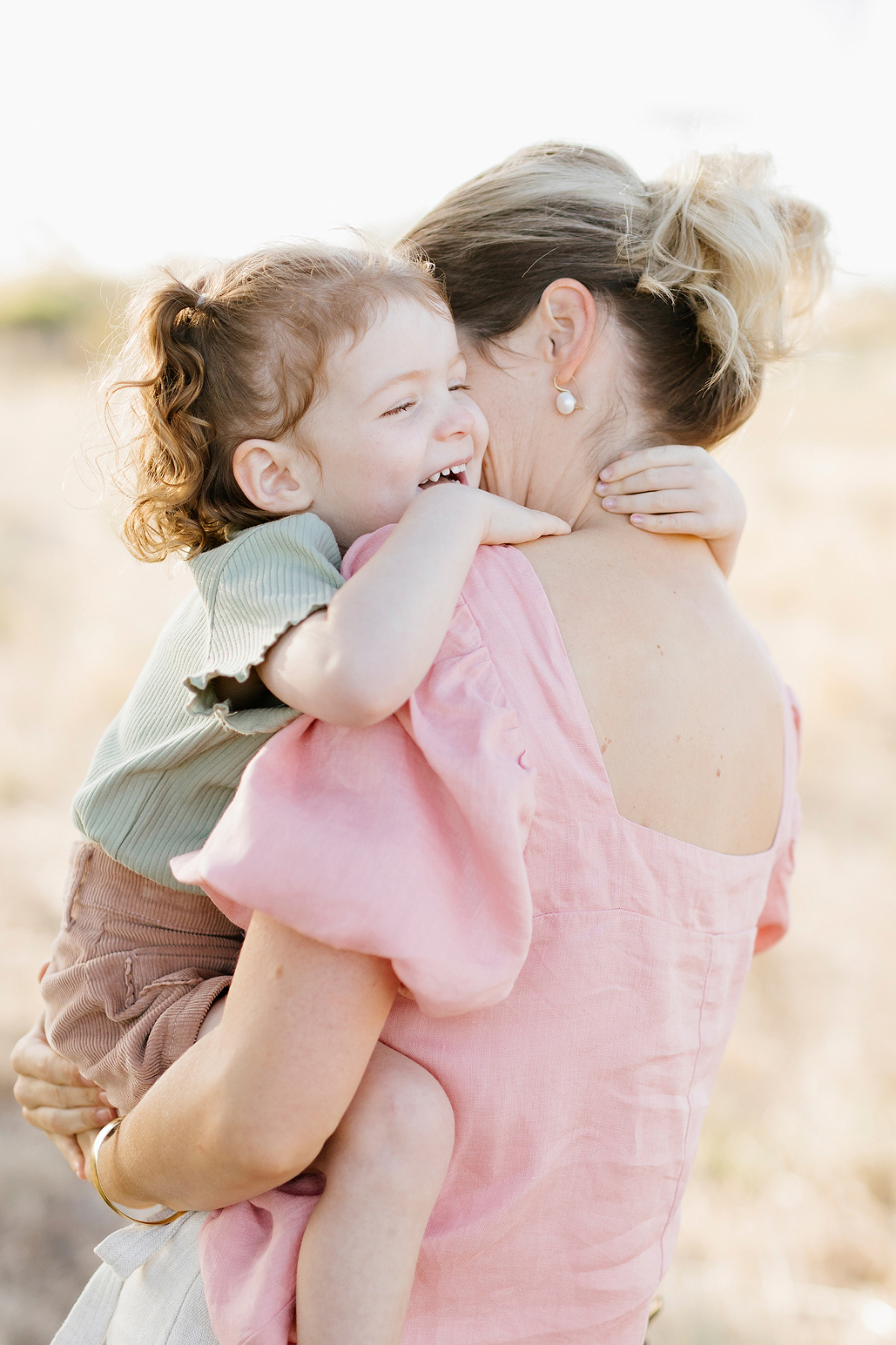 young daughter hugging her mum