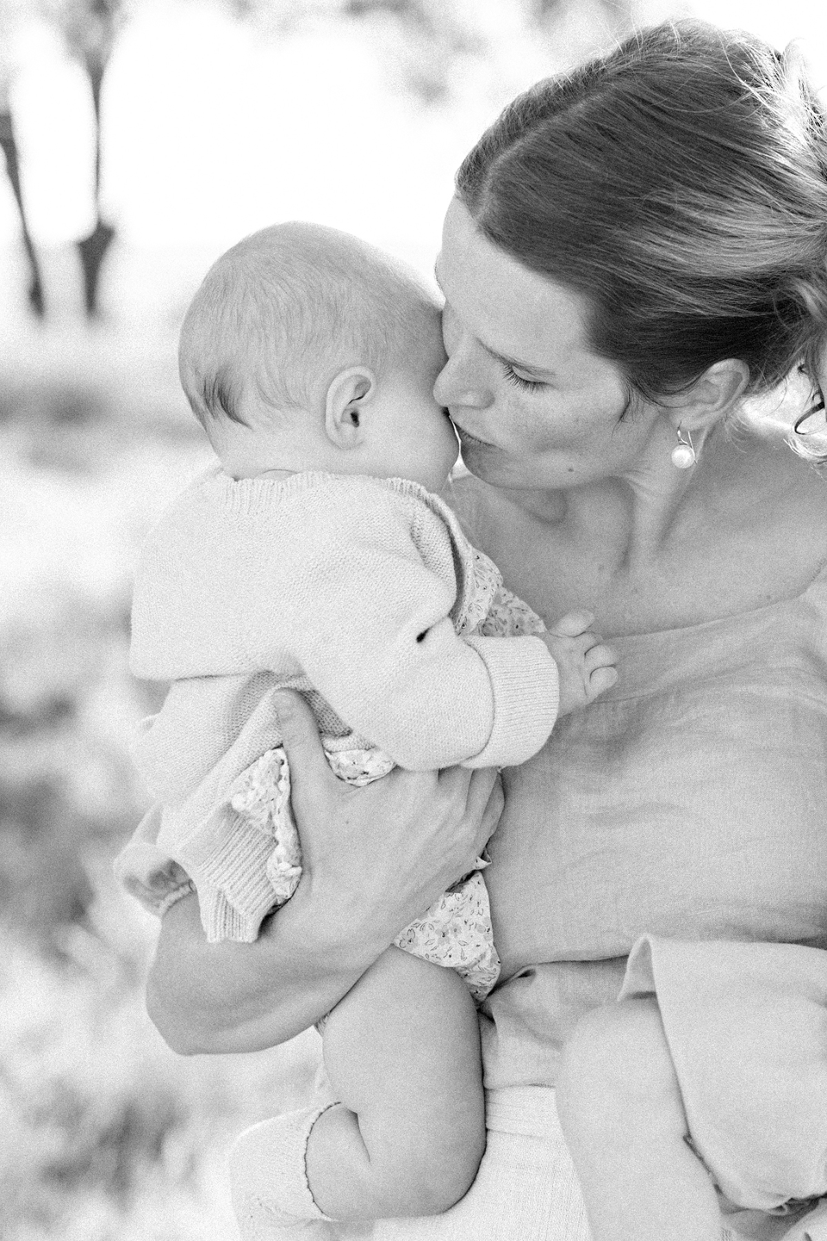 mother kissing her daughter
